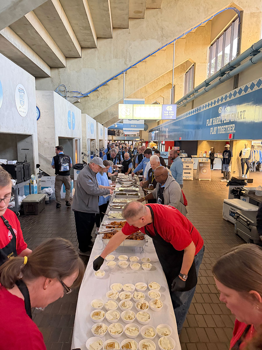 Holy Smokes team serving a long catered buffet line