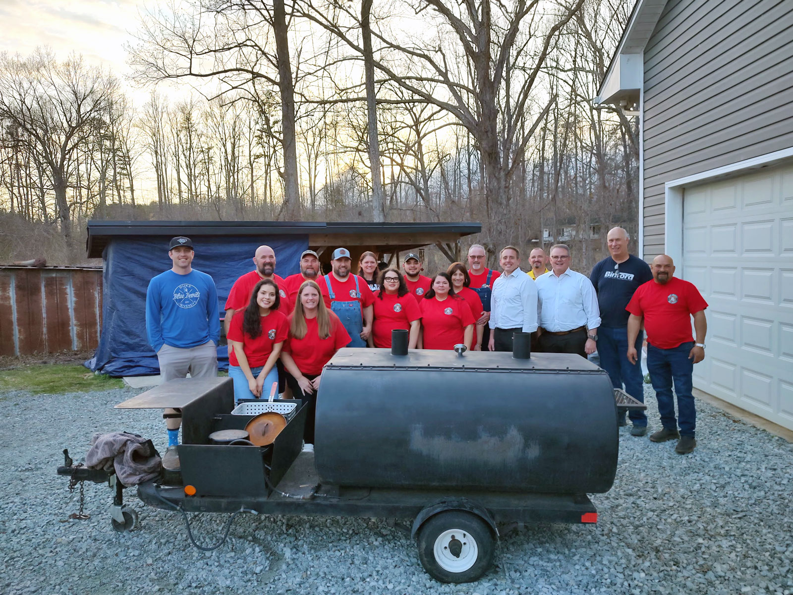The Holy Smokes team gathered around their smoker trailer