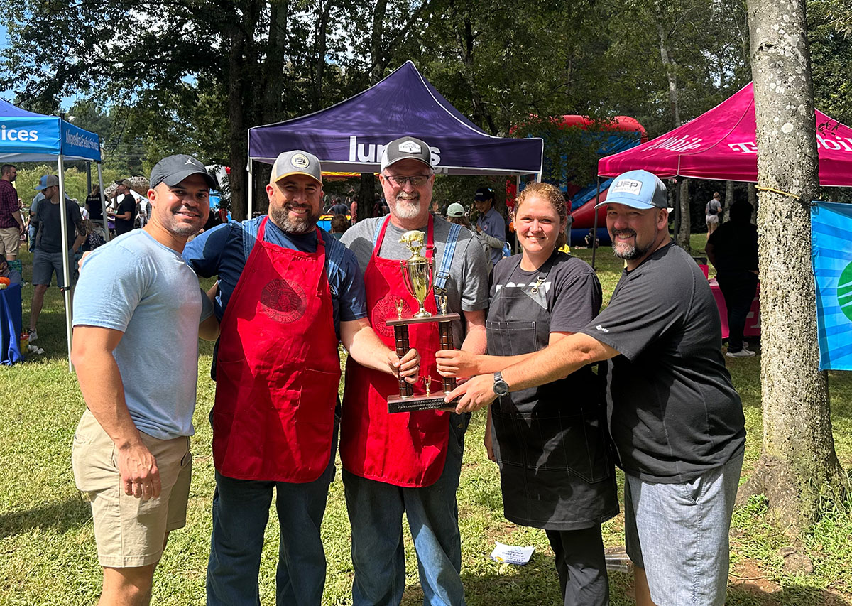 The Holy Smokes team holding their second-place trophy from the Hillsborough Hog Day competition